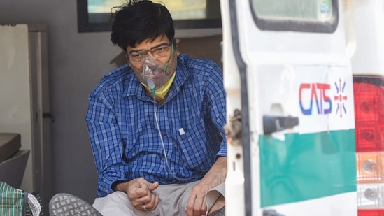 A Covid-19 patient waits in an ambulance outside the LNJP hospital, in New Delhi, Monday, April 26, 2021. (PTI) A Covid-19 patient waits in an ambulance outside the LNJP hospital, in New Delhi, Monday, April 26, 2021. (PTI)