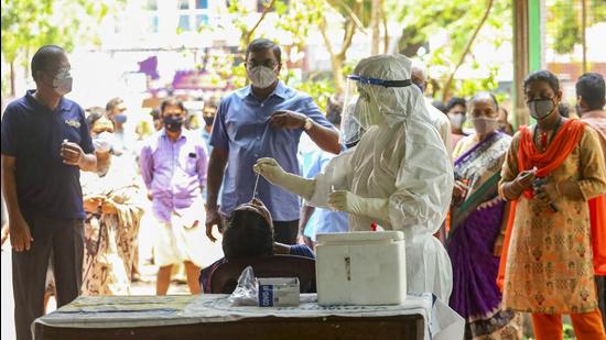 Kozhikode: Health workers take swab samples for COVID-19 testing as coronavirus cases surge in Kerala. (PTI) Kozhikode: Health workers take swab samples for COVID-19 testing as coronavirus cases surge in Kerala. (PTI)