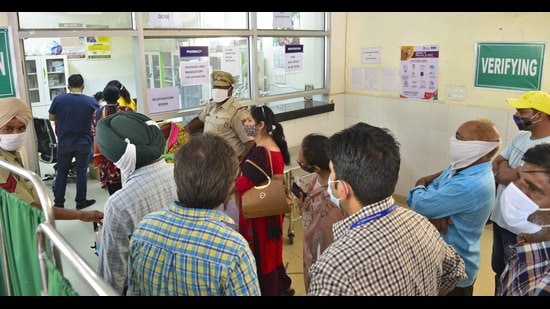 Local residents stand in queues outside a vaccination counter at the civil surgeon’s office in Ludhiana on Tuesday. (Gurpreet Singh/HT)