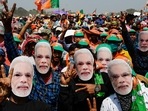 Bharatiya Janata Party (BJP) supporters wear masks of Prime Minister Narendra Modi as they gather for a rally addressed by Modi ahead of West Bengal state elections in Kolkata, India.(AP) Bharatiya Janata Party (BJP) supporters wear masks of Prime Minister Narendra Modi as they gather for a rally addressed by Modi ahead of West Bengal state elections in Kolkata, India.(AP)