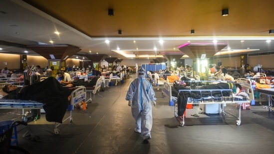 People recuperating inside a temporary Covid Care Centre set up at Shehnai Banquet Hall attached to LNJP Hospital, in New Delhi on April 27. The second wave of infections has seen at least 300,000 people test positive each day for the past week, overwhelming healthcare facilities and crematoriums and fuelling an increasingly urgent international response.(Amal KS / HT Photo)