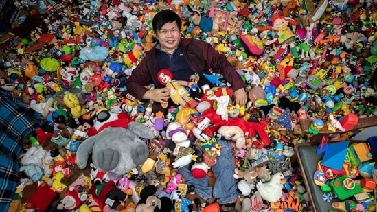 Percival Lugue, who has the Guinness world record for the largest fast-food toy collection, poses with his toy collection in his home in Apalit, Pampanga province, Philippines.(REUTERS)