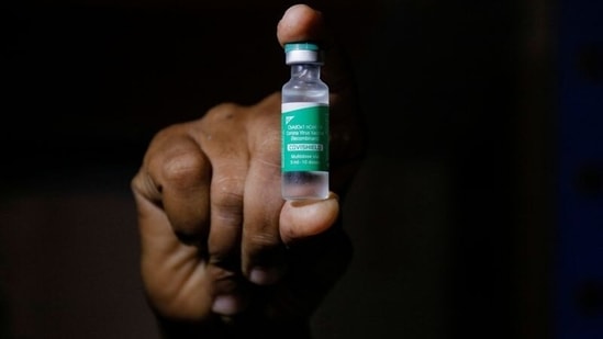 A man displays a vial f AstraZeneca's COVISHIELD vaccine. (REUTERS)