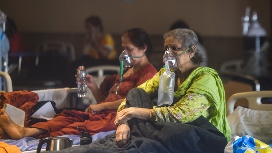 People being administered oxygen at the temporary Covid Care Centre set up at Shehnai Banquet Hall attached to LNJP Hospital, in New Delhi on April 27. The last 24 hours brought 360,960 new cases for the world's largest single-day total, taking India's tally of infections to nearly 18 million.(Amal KS / HT Photo)