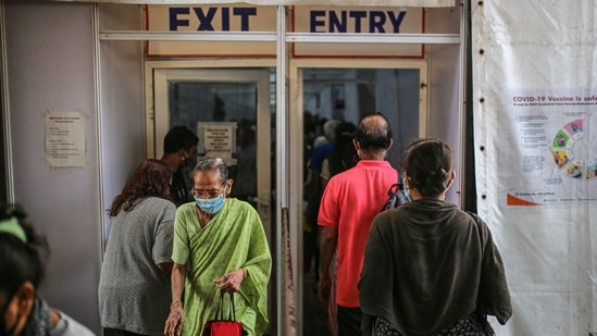 People enter and exit a Covid-19 vaccination center at the BKC NESCO jumbo Covid centre in the Goregaon suburb of Mumbai.(Bloomberg Photo)