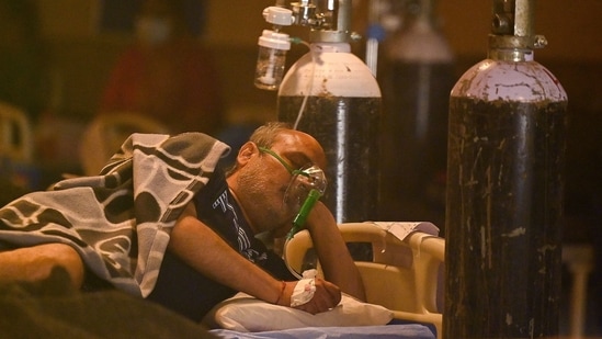 A Covid-19 coronavirus positive patient seen inside a banquet hall temporarily converted into a covid care centre in New Delhi on April 28, 2021.(AFP) A Covid-19 coronavirus positive patient seen inside a banquet hall temporarily converted into a covid care centre in New Delhi on April 28, 2021.(AFP)