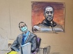 Former Minneapolis police officer Derek Chauvin sits in front of a picture of George Floyd displayed during Chauvin's trial