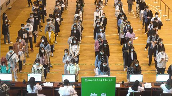 University students queue up to receive the China National Biotec Group’s (CNBG) Covid-19 vaccine at a university in Wuhan in China's central Hubei province. (AFP) University students queue up to receive the China National Biotec Group’s (CNBG) Covid-19 vaccine at a university in Wuhan in China's central Hubei province. (AFP)