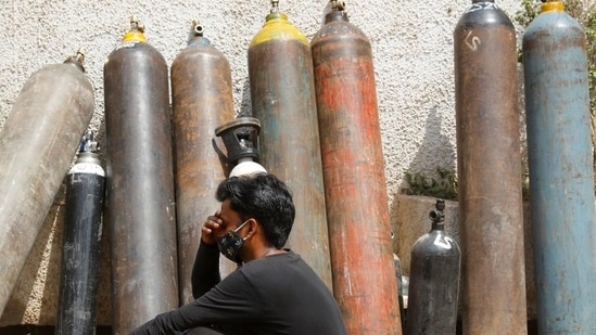A man waits outside a factory to get his oxygen cylinder refilled, amidst the spread of the coronavirus disease (Covid-19) in New Delhi. (Reuters)