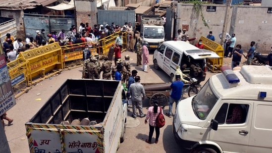 People waiting to refill empty oxygen cylinders at a plant in Naraina, New Delhi on April 27. “The situation is still the same; hospitals are anxious about their oxygen supply. We have had to stop new admissions now because we are not sure when and how much oxygen we will receive,” said an official at one of the biggest private hospitals in Delhi.(Sanjeev Verma / HT Photo)