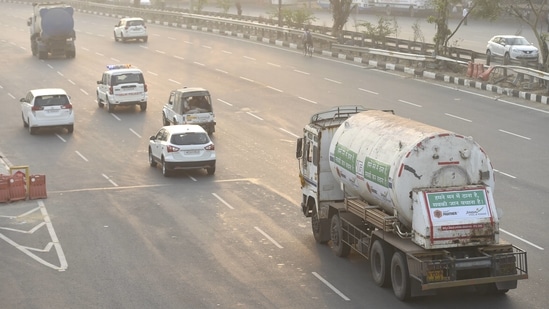 Oxygen tankers being escorted by Delhi Police as they move towards the hospitals from Delhi Cantt Railway Station on April 27. The Delhi government on April 27 received five cryogenic tankers from the Centre, which were being fitted on to trucks and pressed into service. The state expects to receive 18 more such tankers from Bangkok, which were scheduled to arrive on April 28 but got held up due to formalities, according to a government official.(Vijay Verma / PTI)