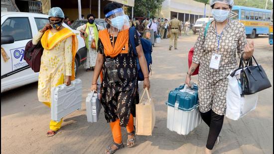 Polling officials carrying EVMs and other polling materials on the eve of the eighth phase of the West Bengal assembly election, at Netaji Indoor Stadium in Kolkata on Wednesday, April 28. (ANI)