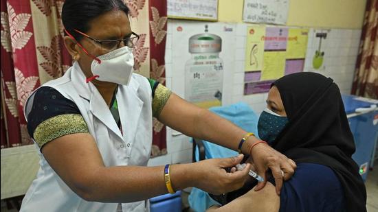 A medical worker inoculates a woman with the Covaxin Covid-19 coronavirus vaccine, at a health centre in New Delhi on April 29. (AFP)