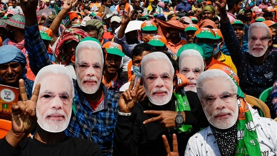 Bharatiya Janata Party (BJP) supporters wear masks of Prime Minister Narendra Modi as they gather for a rally addressed by Modi ahead of West Bengal state elections in Kolkata. (AP) Bharatiya Janata Party (BJP) supporters wear masks of Prime Minister Narendra Modi as they gather for a rally addressed by Modi ahead of West Bengal state elections in Kolkata. (AP)