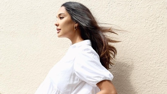 Sharing another photo in a white tent shaped dress, Lisa shared, "This dress has fit from non pregnant life, till now, almost 9months pregnant and beyond." (Instagram)