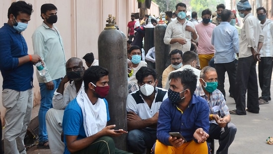 Relatives of Covid-19 patients wait in a queue to refill their oxygen cylinders outside Oudh Oxygen Refilling centre in Lucknow on Thursday. (ANI Photo) Relatives of Covid-19 patients wait in a queue to refill their oxygen cylinders outside Oudh Oxygen Refilling centre in Lucknow on Thursday. (ANI Photo)