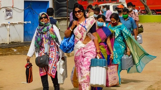 Polling officials leaving a distribution centre after collecting election material on the eve of the second phase of West Bengal Assembly Elections, in Bankura on March 31. The polls were held in the backdrop of surging second wave of the coronavirus pandemic. When the polls were announced, in late February, India was seeing around 15,000 cases a day. On the last day of polling, April 29, it recorded 386,713 cases.(PTI)