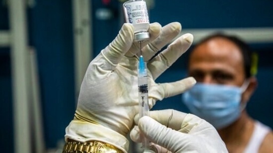 A health worker prepares to administer the COVAXIN vaccine for Covid-19 to a man at an indoor stadium in Guwahati, India, Thursday, April 22, 2021. (AP)