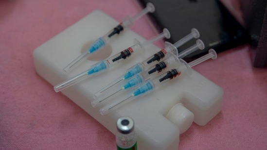 Syringes filled with Covishield vaccine against the Covid-19 lie on ice box at a primary health centre in Srinagar. 