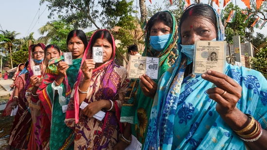 Voters show their ID cards as they arrive to cast their votes during the second phase of West Bengal Assembly polls, in Nandigram on April 1. Despite the elections dragging on for over a month--from March 27 to April 29--voter enthusiasm hardly showed any sign of waning, with the turnout ranging between 76.07 per cent in the 8th phase, held amid a raging Covid-19 pandemic, and 86.11 per cent in the second phase, when the contagion seemed like ebbing away.(Ashok Bhaumik / PTI)