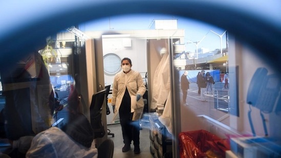 Lab staff process RT-PCR tests at an on-site Covid-19 testing laboratory at Los Angeles International Airport(AFP)