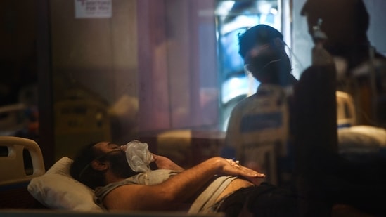 A Covid-19 coronavirus patient rests inside a banquet hall temporarily temporarily converted into a Covid-19 coronavirus ward in New Delhi on April 30, 2021. (AFP) A Covid-19 coronavirus patient rests inside a banquet hall temporarily temporarily converted into a Covid-19 coronavirus ward in New Delhi on April 30, 2021. (AFP)
