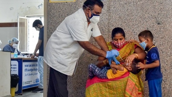 A medic takes sample from a young child for Covid-19 testing in Hyderabad. (PTI Photo)