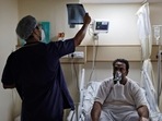 A doctor checks an X-ray of a patient suffering from Covid-19 at a hospital in New Delhi on May 1. India posted a record daily rise of 401,993 new coronavirus cases on May 1 as the country opened up its massive vaccination drive to all adults.