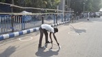 Kolkata: A worker draws markers on the road to ensure social distancing as coronavirus cases spike across the country, outside Netaji Indoor Stadium on the eve of counting day of West Bengal Assembly Poll, in Kolkata, Saturday, May 1, 2021. (PTI Photo/Swapan Mahapatra) Kolkata: A worker draws markers on the road to ensure social distancing as coronavirus cases spike across the country, outside Netaji Indoor Stadium on the eve of counting day of West Bengal Assembly Poll, in Kolkata, Saturday, May 1, 2021. (PTI Photo/Swapan Mahapatra)