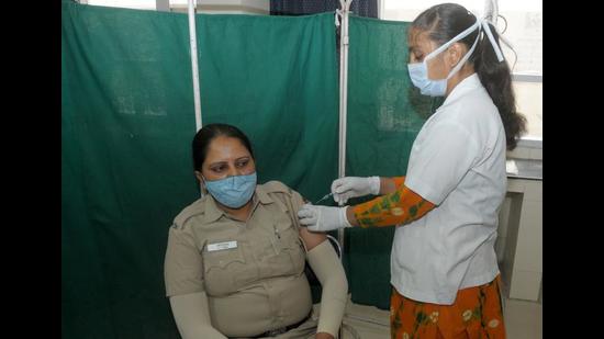 A police personnel receiving the Covid vaccine at a health centre in Sector 8, Chandigarh, on Saturday. (Ravi Kumar/HT) A police personnel receiving the Covid vaccine at a health centre in Sector 8, Chandigarh, on Saturday. (Ravi Kumar/HT)