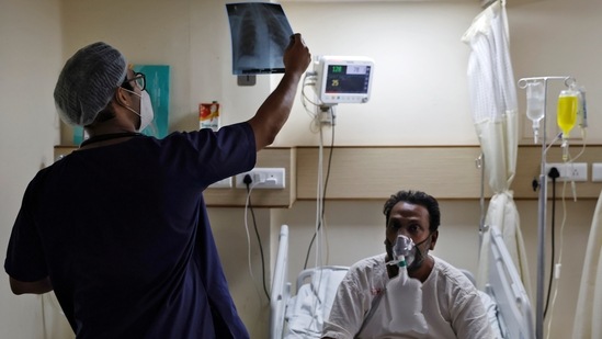 A doctor checks an X-ray of a patient suffering from Covid-19 at a hospital in New Delhi on May 1. India posted a record daily rise of 401,993 new coronavirus cases on May 1 as the country opened up its massive vaccination drive to all adults.(Danish Siddiqui / REUTERS)