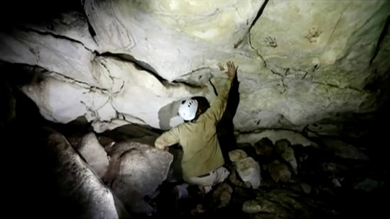 Archeologist Sergio Grosjean explores a cave with hand prints, reportedly 1,200 years old, in Merida, Mexico. (via REUTERS)