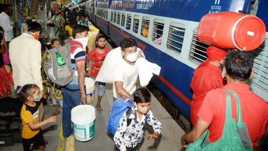 Migrants board a train to their home states in Bihar as coronavirus cases surge across the country. (PTI) Migrants board a train to their home states in Bihar as coronavirus cases surge across the country. (PTI)