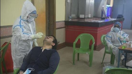 File photo: Kolkata Municipal Corporation (KMC) health staff member collects a swab sample from a man to test for Covid-19 infection (Samir Jana / Hindustan Times) File photo: Kolkata Municipal Corporation (KMC) health staff member collects a swab sample from a man to test for Covid-19 infection (Samir Jana / Hindustan Times)