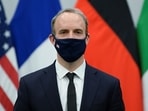 Britain's foreign secretary Dominic Raab wears a protective mask.