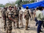 Security personnel keep vigil at a polling station in Sitalkuchi .(PTI) Security personnel keep vigil at a polling station in Sitalkuchi .(PTI)