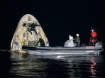 Support teams work around the SpaceX Crew Dragon Resilience spacecraft shortly after it landed with NASA astronauts. Support teams work around the SpaceX Crew Dragon Resilience spacecraft shortly after it landed with NASA astronauts.