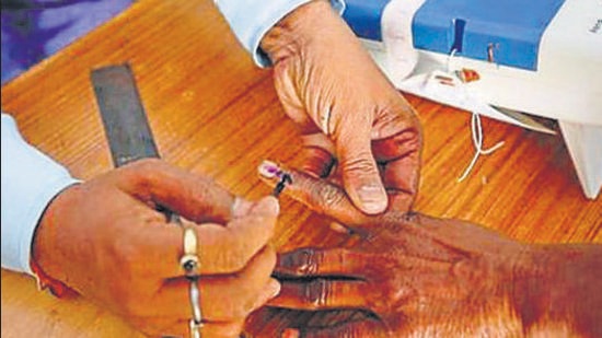 File photo: A polling officer puts indelible ink on the finger of a voter at a polling station. (AP)