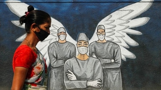 A woman wearing a face mask walks past a Covid-19 graffiti in Navi Mumbai. (Reuters/ File photo) A woman wearing a face mask walks past a Covid-19 graffiti in Navi Mumbai. (Reuters/ File photo)