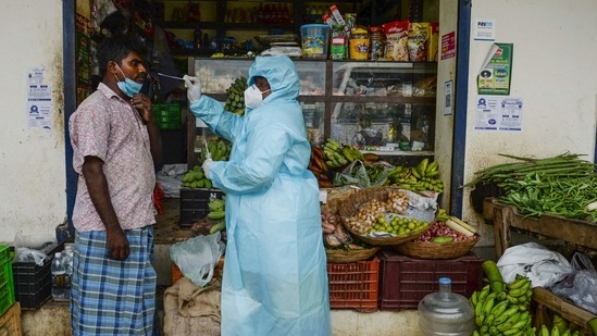 A health worker taking a swab sample from a shopkeeper for a RT-PCR Covid-19 coronavirus test in Chennai. (Arun Sankar / AFP) A health worker taking a swab sample from a shopkeeper for a RT-PCR Covid-19 coronavirus test in Chennai. (Arun Sankar / AFP)