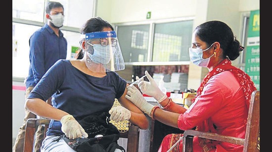 A medico administers a dose of Covid-19 vaccine to a woman during the third phase of inoculation drive in Gurugram on Sunday. (PTI) A medico administers a dose of Covid-19 vaccine to a woman during the third phase of inoculation drive in Gurugram on Sunday. (PTI)