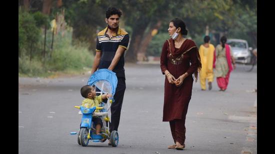 A family out for a walk without masks amid the weekend curfew at Panchkula’s Sector 11 on Sunday. (Sant Arora/HT) A family out for a walk without masks amid the weekend curfew at Panchkula’s Sector 11 on Sunday. (Sant Arora/HT)