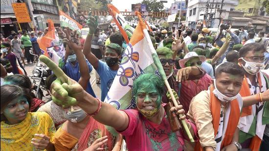 TMC workers celebrate the winning trend of the party in the state assembly polls, in Kolkata on Sunday, May 2. (PTI)