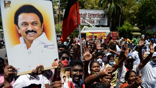 DMK party cadre carry placards with the image of MK Stalin as they celebrate the results at the party headquarters in Chennai on Sunday.(AFP)