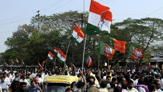 Congress and BJP supporters wave flags in a show of strength in this file picture from 2015. ( Arun Mondhe/ Hindustan Times) Congress and BJP supporters wave flags in a show of strength in this file picture from 2015. ( Arun Mondhe/ Hindustan Times)