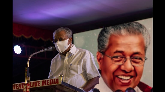 Communist Party of India (Marxist) leader and Kerala Chief Minister Pinarayi Vijayan, whose photograph is on right, addresses an election campaign wearing a mask in Kochi, India, Saturday, March 27, 2021. The southern state goes to polls on April 6 to elect members to its state legislature. (AP Photo/R S Iyer) (AP) Communist Party of India (Marxist) leader and Kerala Chief Minister Pinarayi Vijayan, whose photograph is on right, addresses an election campaign wearing a mask in Kochi, India, Saturday, March 27, 2021. The southern state goes to polls on April 6 to elect members to its state legislature. (AP Photo/R S Iyer) (AP)