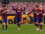 Barcelona's Lionel Messi celebrates scoring their first goal with teammates.