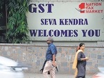 Pedestrians walk in front of a board advertising Goods and Service Tax (GST) in front of the Central Goods and Service Tax office in Bangalore.(AFP/For Representative Purposes Only) Pedestrians walk in front of a board advertising Goods and Service Tax (GST) in front of the Central Goods and Service Tax office in Bangalore.(AFP/For Representative Purposes Only)