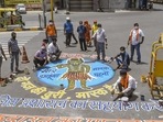 Artists and activists paint a 'rangoli' to create awareness on COVID-19, during the second wave of coronavirus pandemic in India, in Jodhpur