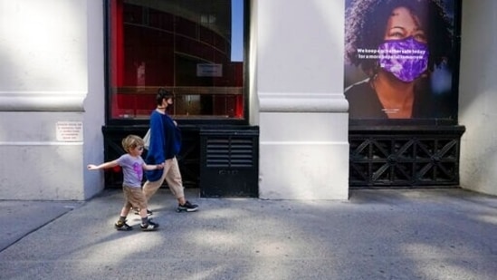 Pedestrians walk past a poster hanging in at a NYU building in New York. (AP) Pedestrians walk past a poster hanging in at a NYU building in New York. (AP)